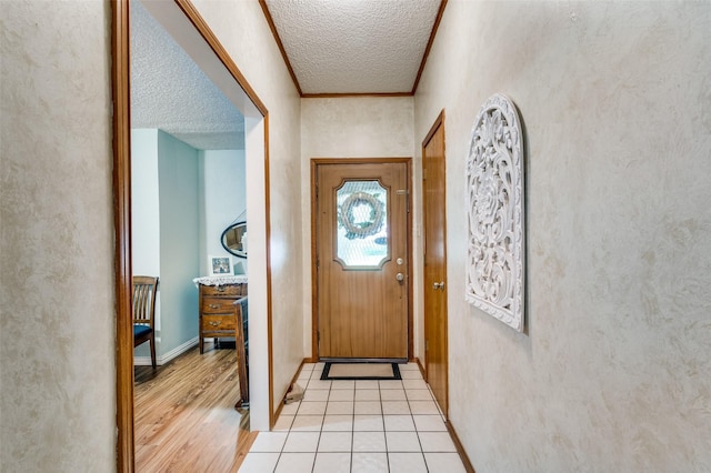 1001 Woodhaven Ct, Euless, TX 76039 - doorway to outside featuring a textured ceiling, light wood-style floors, and baseboards