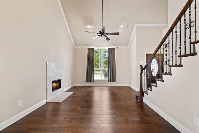 7603 Cousteau Dr, Rowlett, TX 75088 - unfurnished living room featuring a fireplace, ceiling fan, stairs, ornamental molding, and wood-type flooring
