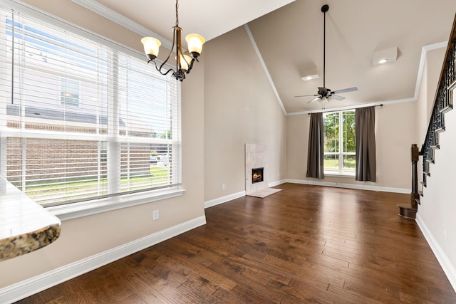 7603 Cousteau Dr, Rowlett, TX 75088 - unfurnished living room featuring stairway, dark wood-type flooring, lofted ceiling, baseboards, and crown molding