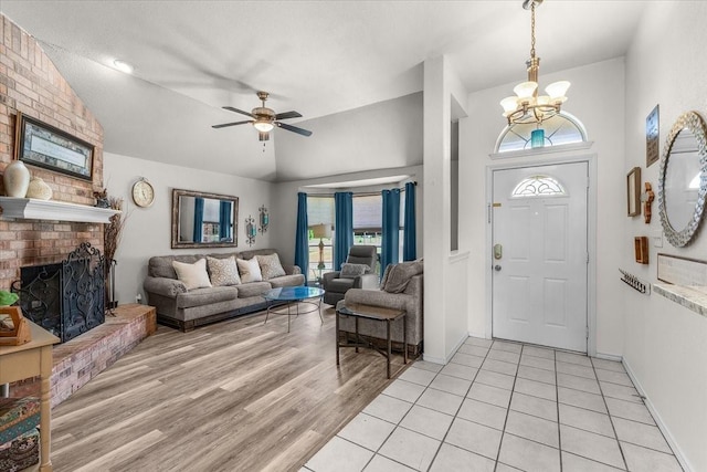 5212 Cross Timber Rd W, Cleburne, TX 76031 - entryway featuring a chandelier, vaulted ceiling, a brick fireplace, healthy amount of natural light, and ceiling fan