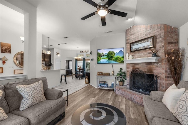 5212 Cross Timber Rd W, Cleburne, TX 76031 - living room with ceiling fan, a brick fireplace, and light wood finished floors