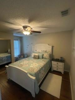 2510 Plumdale Dr, Carrollton, TX 75006 - bedroom featuring dark wood-style flooring, a ceiling fan, and baseboards
