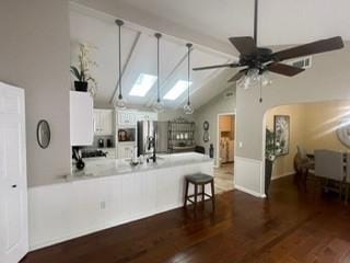 2510 Plumdale Dr, Carrollton, TX 75006 - kitchen featuring a peninsula, white cabinetry, light countertops, stainless steel refrigerator with ice dispenser, and wood finished floors