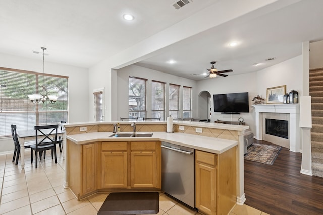 107 Barkley Dr, Hickory Creek, TX 75065 - kitchen featuring stainless steel dishwasher, light countertops, a ceiling fan, a chandelier, and a tile fireplace