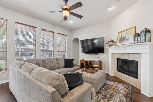 107 Barkley Dr, Hickory Creek, TX 75065 - living room with a ceiling fan, dark wood-style floors, baseboards, arched walkways, and a tiled fireplace