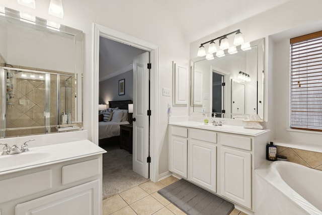 107 Barkley Dr, Hickory Creek, TX 75065 - ensuite bathroom with two vanities, a stall shower, tile patterned floors, a garden tub, and vaulted ceiling