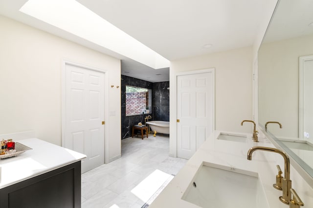 2020 Winding Hollow Ln, Plano, TX 75093 - full bath featuring double vanity, a freestanding tub, and marble look tile flooring