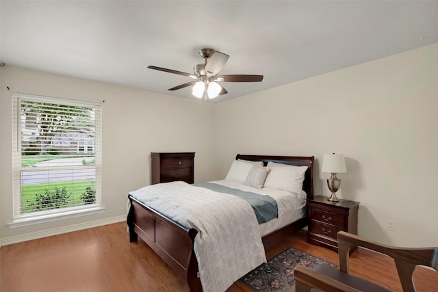 9718 Burney Dr, Dallas, TX 75243 - bedroom featuring wood finished floors, baseboards, and ceiling fan