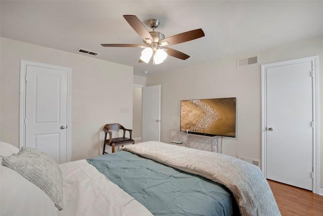 9718 Burney Dr, Dallas, TX 75243 - bedroom featuring wood finished floors and a ceiling fan