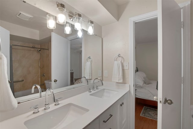 9718 Burney Dr, Dallas, TX 75243 - ensuite bathroom with double vanity, wood finished floors, and bathing tub / shower combination