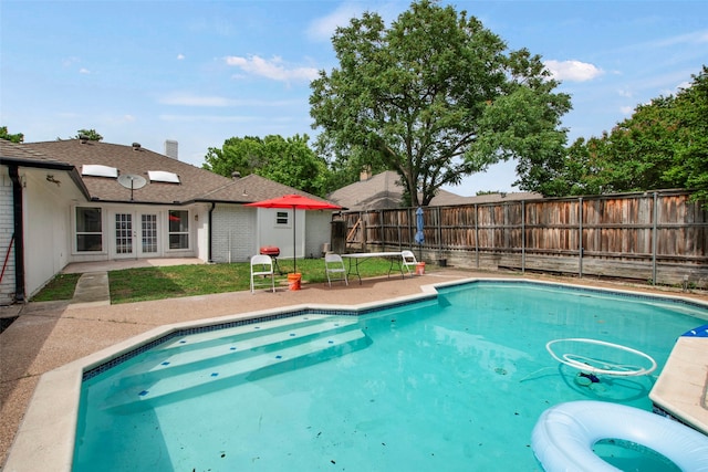 9718 Burney Dr, Dallas, TX 75243 - view of swimming pool with french doors, a patio, and a fenced backyard