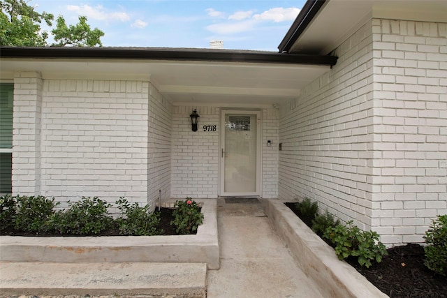 9718 Burney Dr, Dallas, TX 75243 - property entrance featuring brick siding