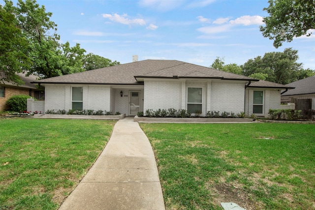 9718 Burney Dr, Dallas, TX 75243 - view of front of house with a front lawn, brick siding, and a shingled roof
