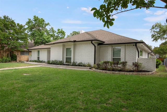 9718 Burney Dr, Dallas, TX 75243 - view of front facade with a front yard, roof with shingles, brick siding, and a chimney