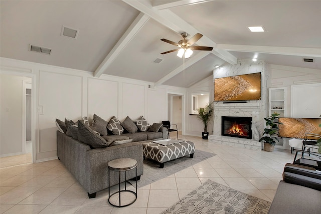 9718 Burney Dr, Dallas, TX 75243 - living area with light tile patterned flooring, a decorative wall, a large fireplace, and ceiling fan