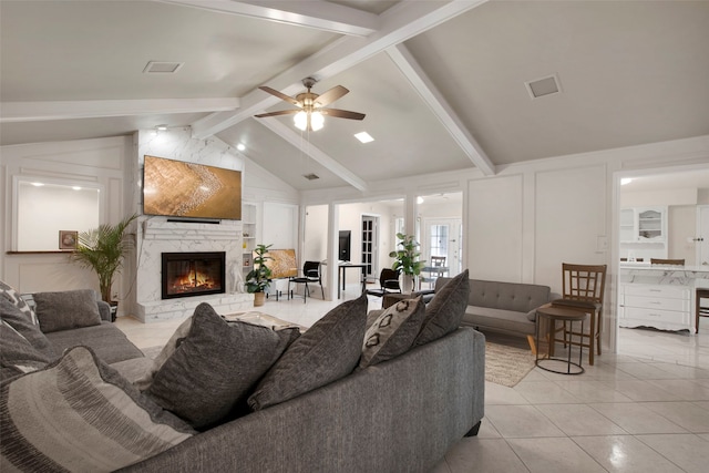 9718 Burney Dr, Dallas, TX 75243 - living room featuring light tile patterned flooring, a ceiling fan, and a large fireplace