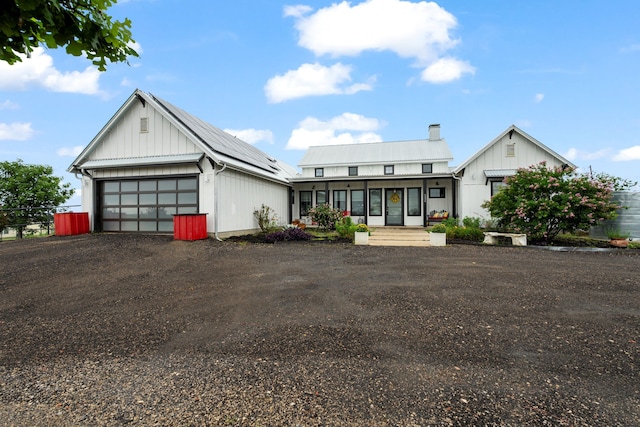 1234 Shelby Ln, Celina, TX 75009 - modern farmhouse with board and batten siding, a porch, metal roof, a detached garage, and a chimney