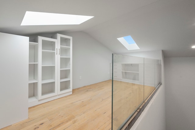 1234 Shelby Ln, Celina, TX 75009 - additional living space with a skylight, lofted ceiling, and wood finished floors