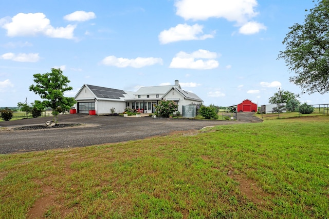 1234 Shelby Ln, Celina, TX 75009 - view of front of home featuring a garage, solar panels, and asphalt driveway