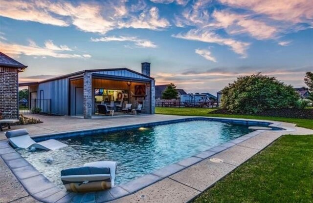 2113 Twin Creeks Cir, Pilot Point, TX 76258 - pool at dusk with an outdoor pool and a patio area
