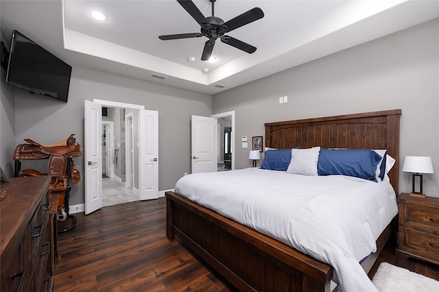2113 Twin Creeks Cir, Pilot Point, TX 76258 - bedroom featuring a tray ceiling, dark wood-style floors, a ceiling fan, recessed lighting, and ensuite bathroom