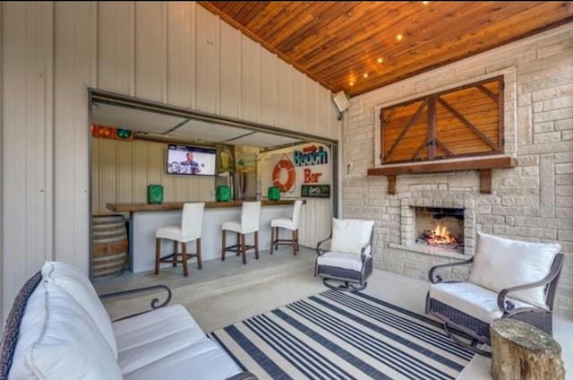2113 Twin Creeks Cir, Pilot Point, TX 76258 - living room with a stone fireplace, wooden ceiling, and wooden walls