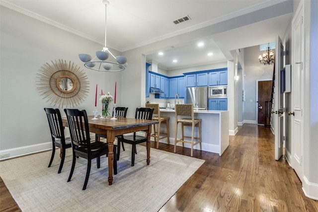 5152 Vickery Blvd, Dallas, TX 75206 - dining space featuring a chandelier, dark wood-type flooring, crown molding, baseboards, and recessed lighting