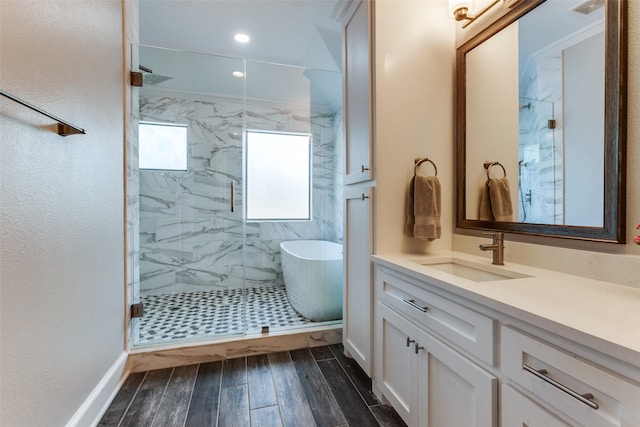 5152 Vickery Blvd, Dallas, TX 75206 - bathroom with a marble finish shower, a freestanding tub, vanity, baseboards, and wood finished floors