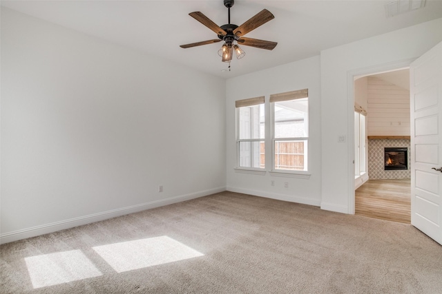 8235 Ottowa Rdg, Frisco, TX 75034 - spare room with light colored carpet, a tile fireplace, baseboards, and ceiling fan