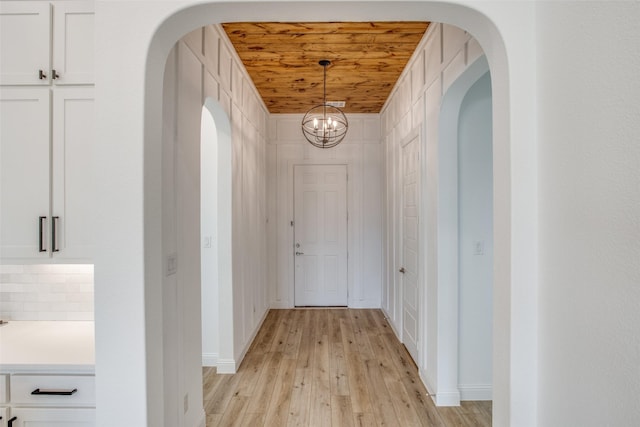 8235 Ottowa Rdg, Frisco, TX 75034 - hall with light wood-style floors, a chandelier, wooden ceiling, and baseboards