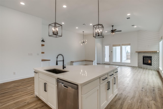 8235 Ottowa Rdg, Frisco, TX 75034 - kitchen with dishwasher, a sink, open floor plan, a chandelier, and light wood-style flooring