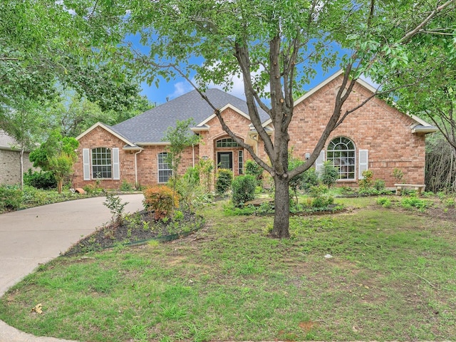 1536 Valley Creek Rd, Denton, TX 76205 - traditional-style home with brick siding and roof with shingles