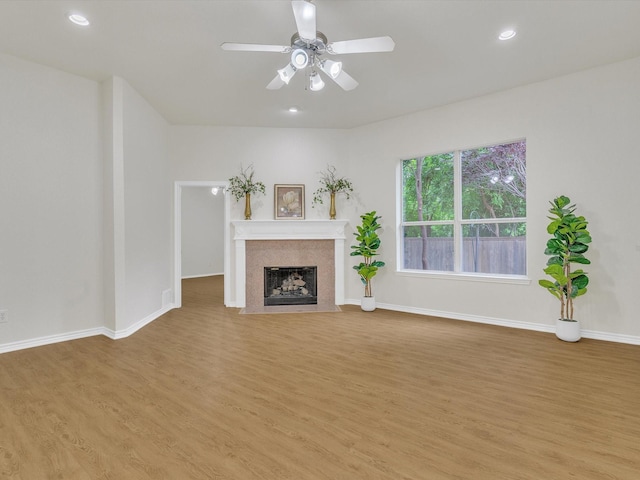 1536 Valley Creek Rd, Denton, TX 76205 - unfurnished living room with light wood-style flooring, a ceiling fan, a fireplace with flush hearth, and recessed lighting