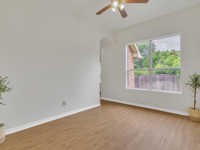 1536 Valley Creek Rd, Denton, TX 76205 - empty room with arched walkways, light wood finished floors, and a ceiling fan