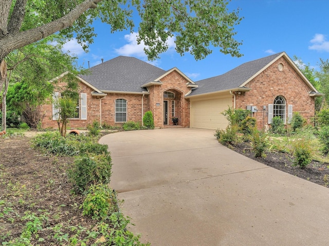 1536 Valley Creek Rd, Denton, TX 76205 - view of front of house featuring brick siding, a shingled roof, a garage, and concrete driveway