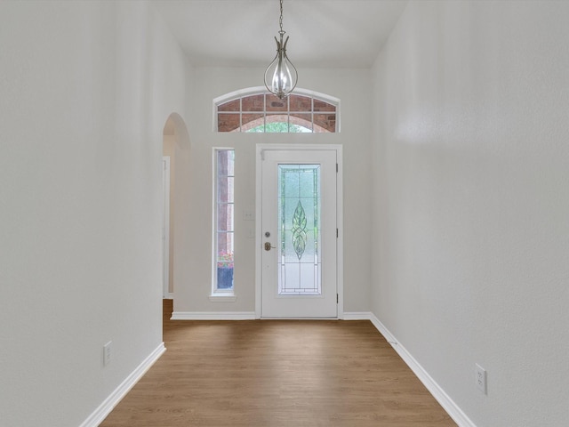 1536 Valley Creek Rd, Denton, TX 76205 - entrance foyer with arched walkways, wood finished floors, and a chandelier