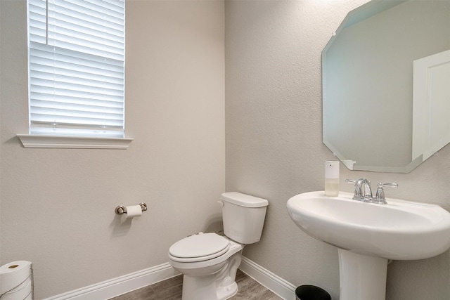 240 Gill Point Ln, Aledo, TX 76008 - bathroom featuring toilet, wood finished floors, baseboards, and a sink