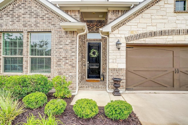 240 Gill Point Ln, Aledo, TX 76008 - view of exterior entry featuring brick siding, an attached garage, and stone siding