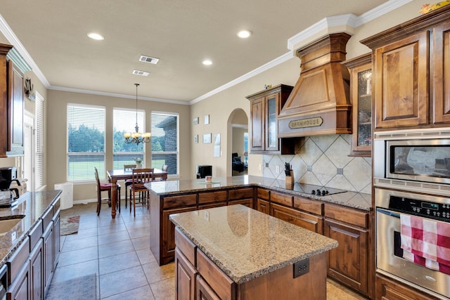 3630 Billy Ray Rd, Midlothian, TX 76065 - kitchen with appliances with stainless steel finishes, a peninsula, arched walkways, a chandelier, and brown cabinets