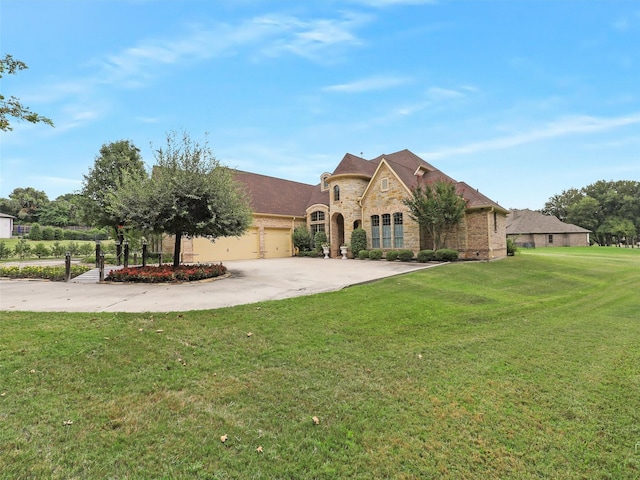 10513 Silver Fox Ct, Fort Worth, TX 76108 - french country inspired facade featuring an attached garage, stone siding, a front lawn, driveway, and brick siding