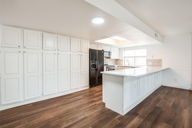 3113 E Park Blvd, Plano, TX 75074 - kitchen with appliances with stainless steel finishes, a peninsula, dark wood finished floors, and white cabinets