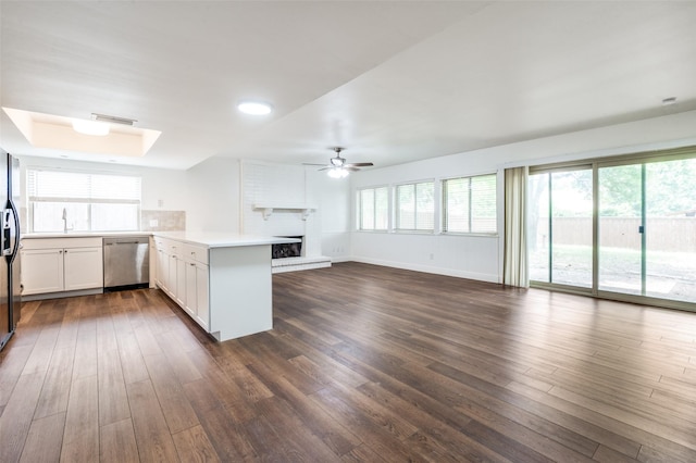 3113 E Park Blvd, Plano, TX 75074 - kitchen featuring stainless steel dishwasher, a peninsula, dark wood finished floors, ceiling fan, and a large fireplace