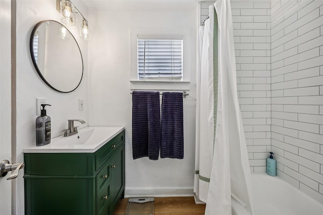 604 N Benge St, Mckinney, TX 75069 - full bath with vanity, shower / tub combo, wood finished floors, and baseboards