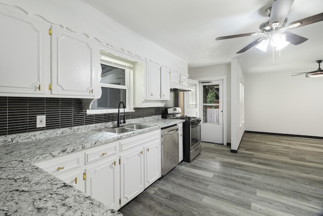 224 Brown Trl, Hurst, TX 76053 - kitchen featuring a sink, stainless steel appliances, backsplash, white cabinetry, and a ceiling fan