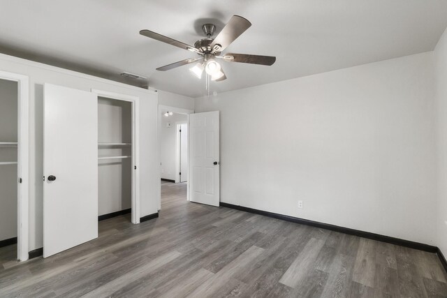 224 Brown Trl, Hurst, TX 76053 - unfurnished bedroom featuring wood finished floors, baseboards, a ceiling fan, and a closet