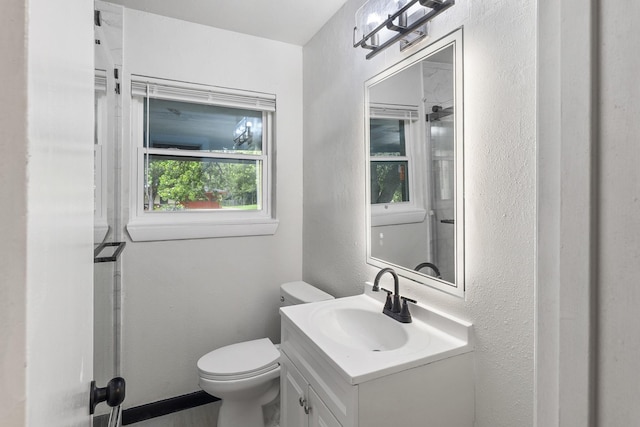 224 Brown Trl, Hurst, TX 76053 - bathroom featuring toilet, vanity, and a textured wall