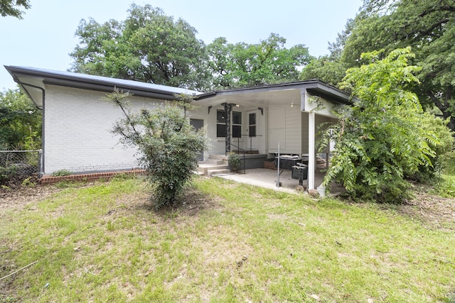 224 Brown Trl, Hurst, TX 76053 - back of house featuring brick siding and a patio
