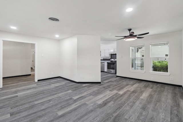 224 Brown Trl, Hurst, TX 76053 - unfurnished living room featuring ceiling fan, wood finished floors, baseboards, and recessed lighting