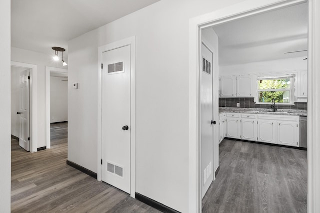 224 Brown Trl, Hurst, TX 76053 - hallway featuring dark wood-style floors, a sink, and baseboards