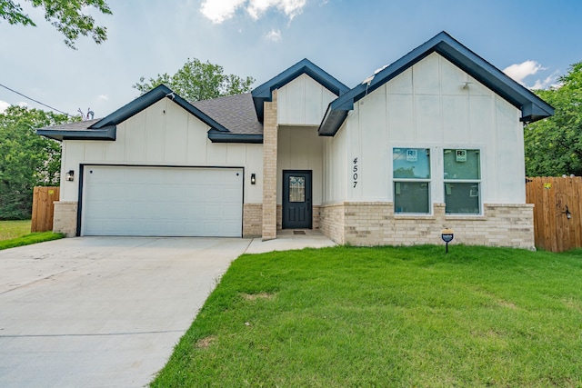 4507 Metropolitan Ave, Dallas, TX 75210 - view of front facade with board and batten siding, a garage, driveway, and a shingled roof
